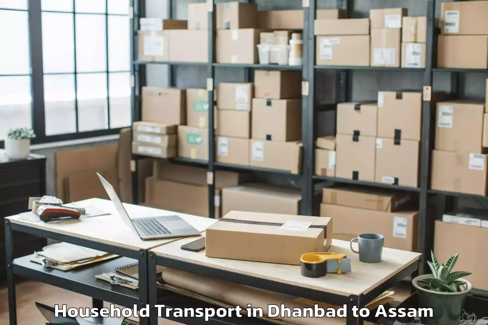 Top Dhanbad to Raha Gaon Household Transport Available